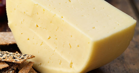 A wedge of Swedish Hushållsost cheese